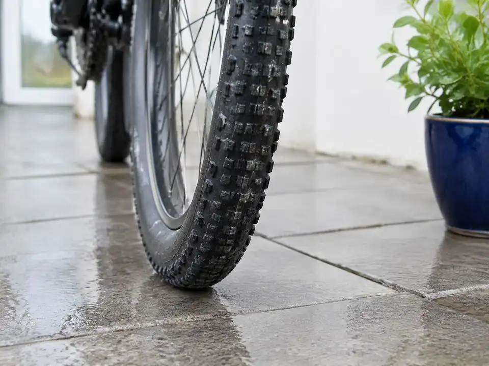 Close view of a bike tyre tread on wet pavement